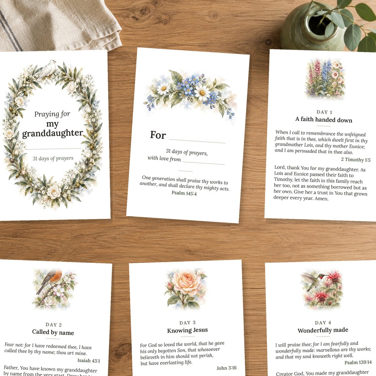 Six printable cards laid out in a grid on a kitchen table, with a napkin and a small vase